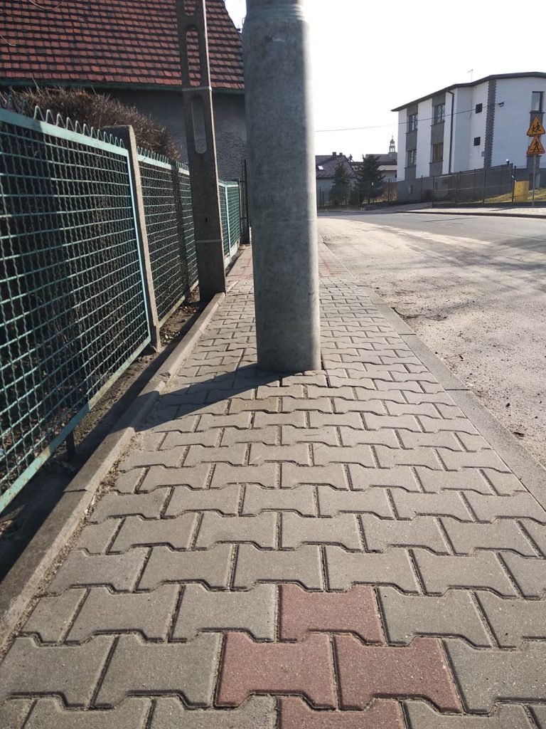 Słup na środku chodnika przy szkole dla niepełnosprawnych