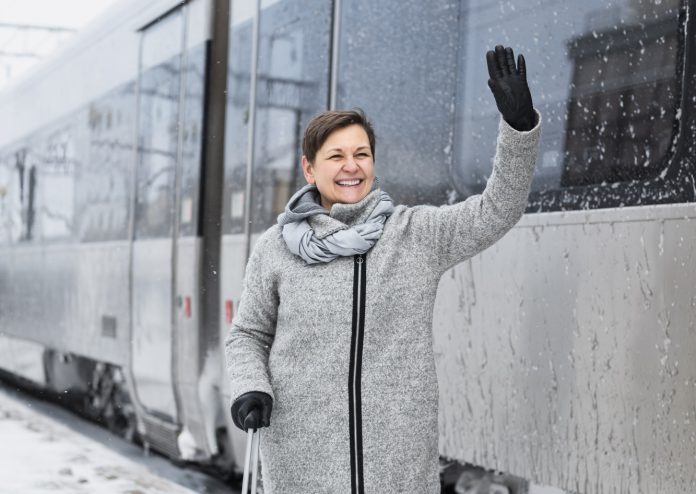 full shot happy woman with baggage