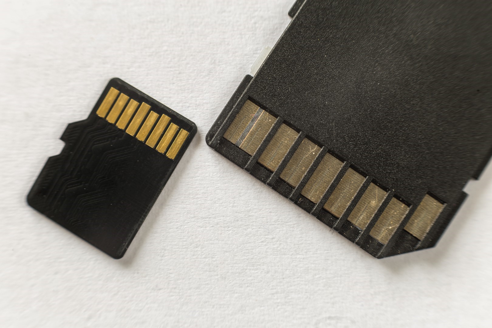Close up of micro SD memory card and SD adapter isolated on white copy space background. Modern technology concept.